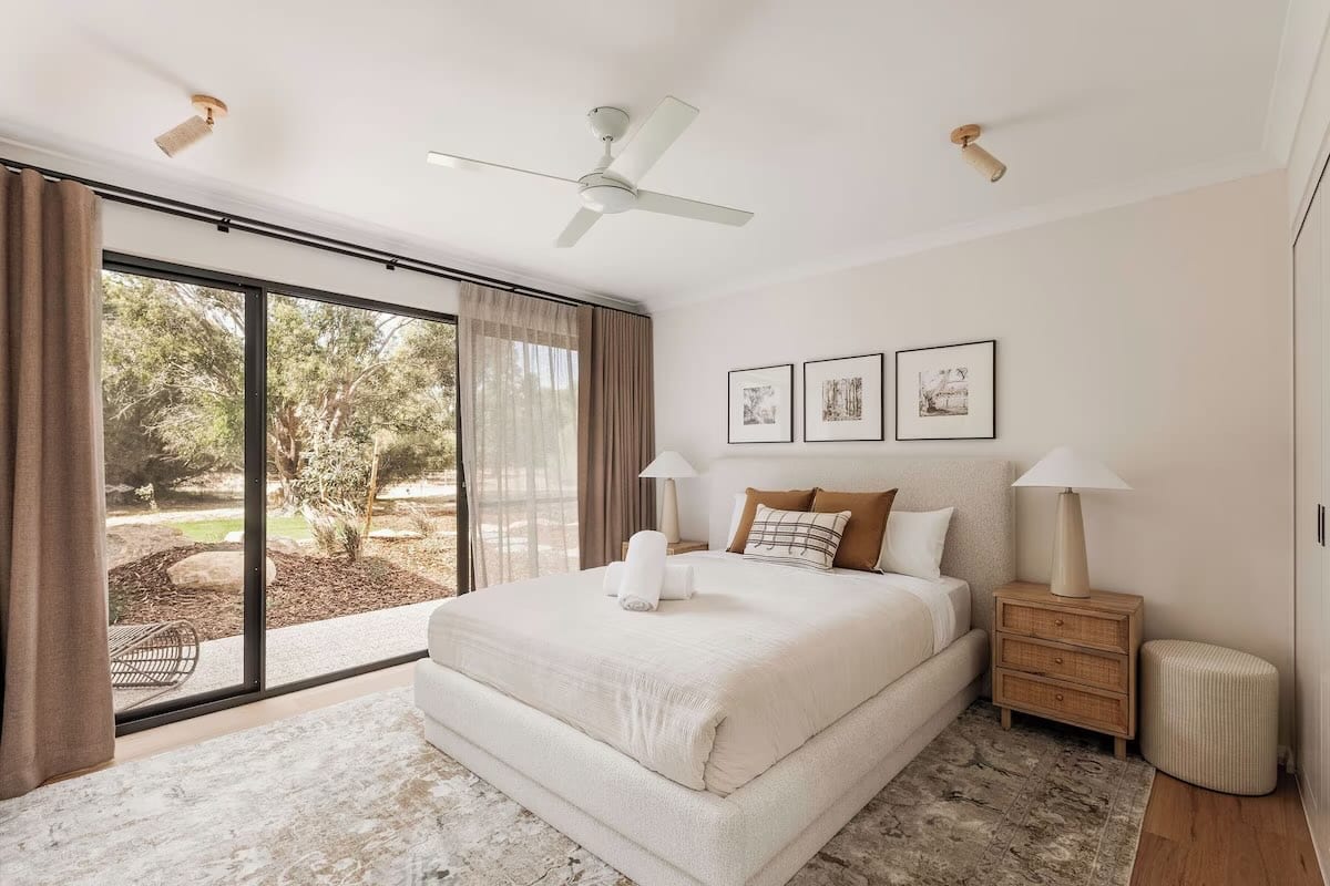 Modern bedroom with large windows and neutral decor