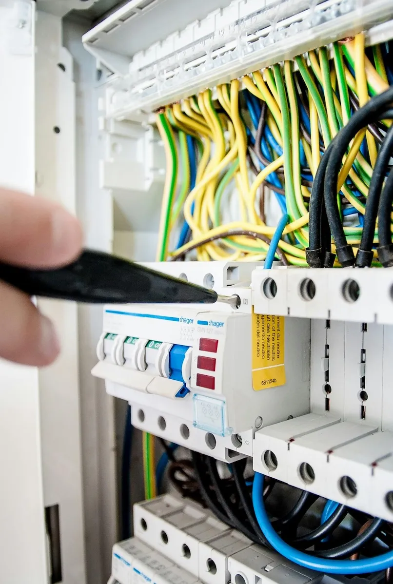 Electrician working on electrical circuit breaker panel